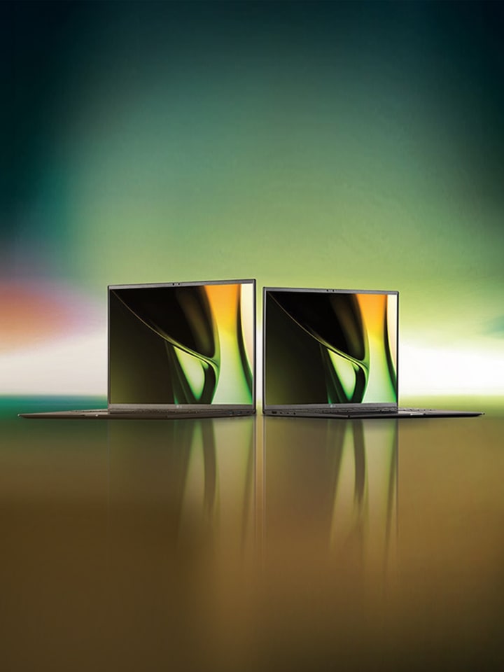 Two LG laptops side by side with vibrant, abstract displays on the screens.