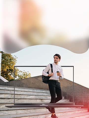  Man in business casual attire holding a coffee carries a backpack. There is an LG Ultra PC on the screen. 