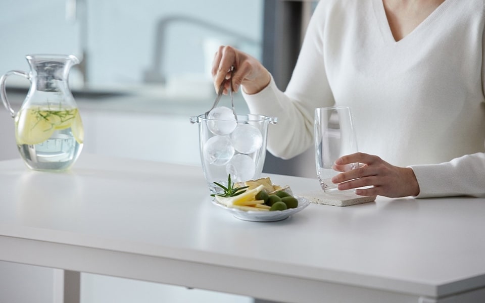 A woman is making ice balls at home.