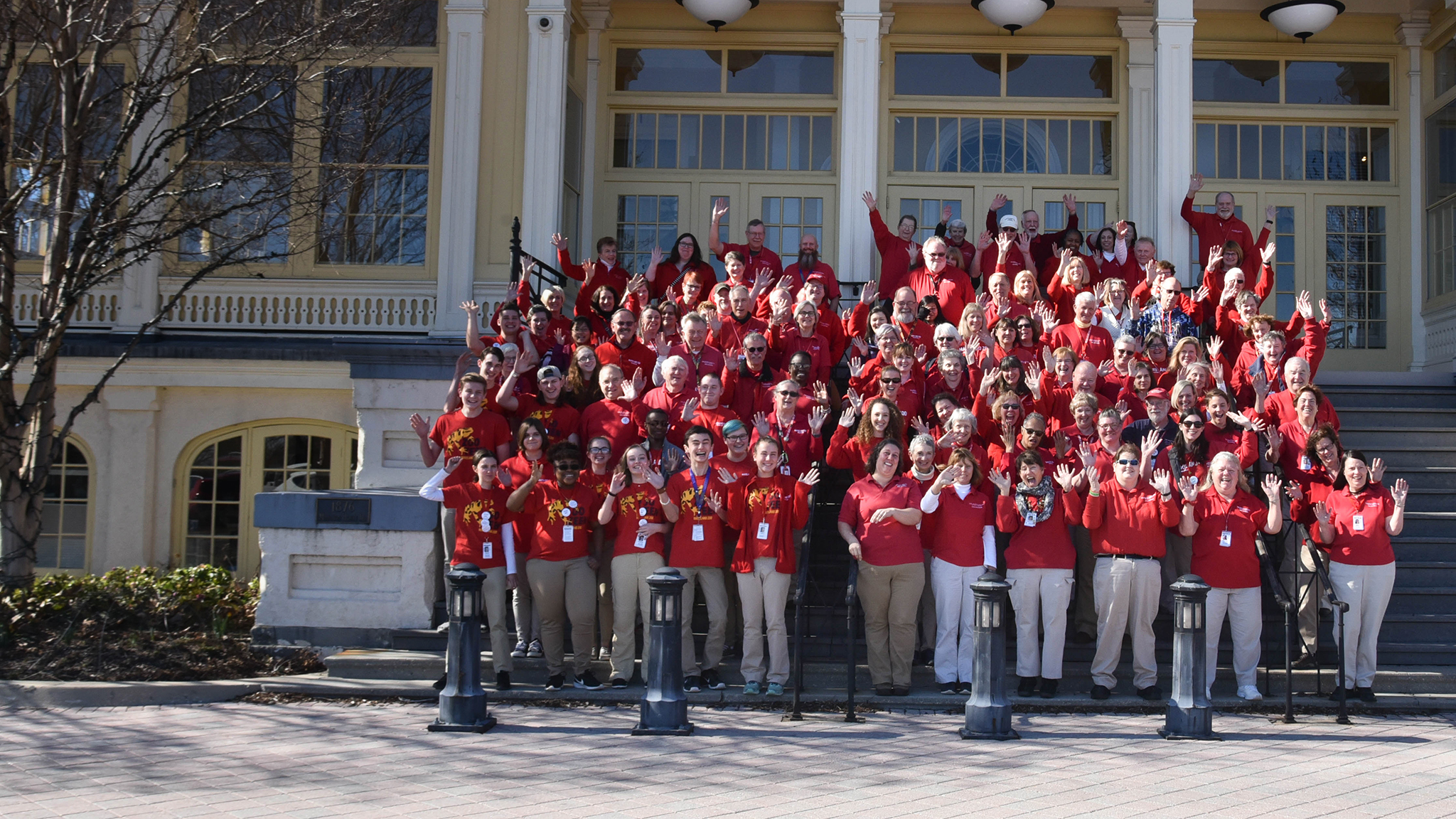 Large group of volunteers waving