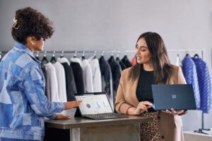 Two retail workers looking at tablet