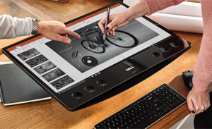 An image of two workers collaborating on a model of a bicycle with ink in PowerPoint.