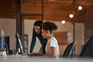 a man and a woman looking at a computer screen