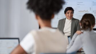 CISO (chief information security officer) presents to the board of executives on security topics in a conference room setting.