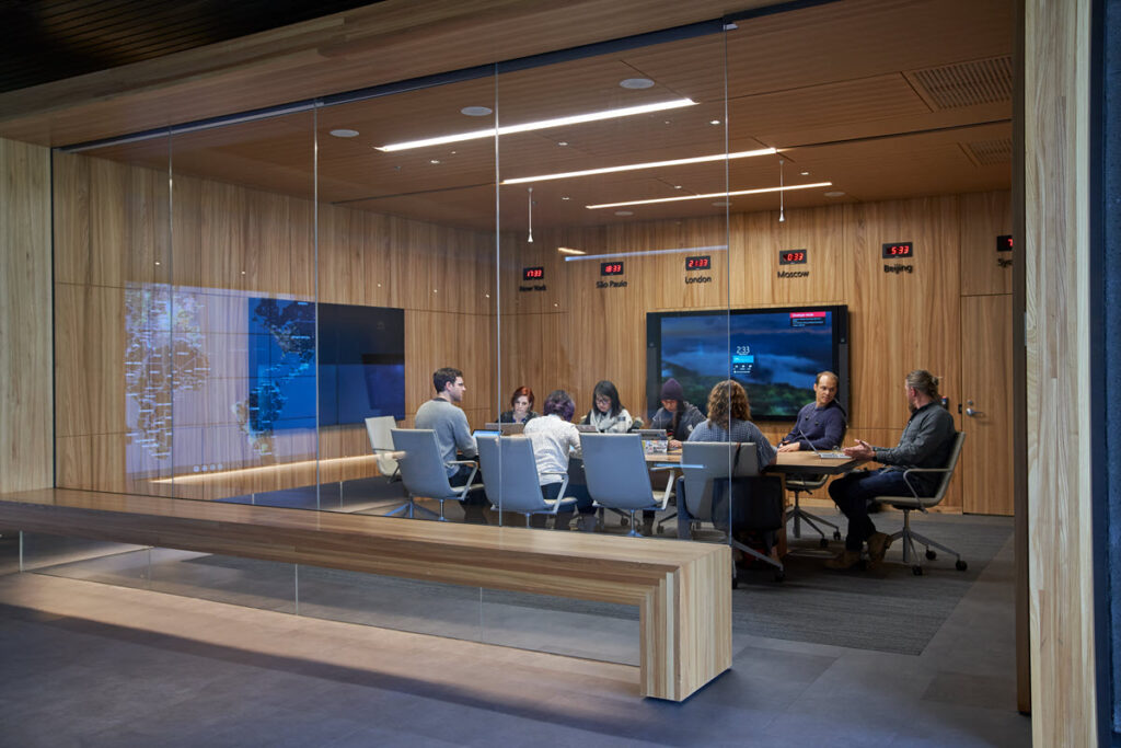 a conference room of people sitting around a table