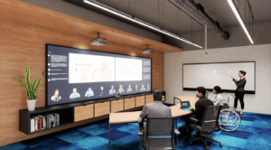 Three people who are physically in a conference room look at a wall display where the online meeting participants are arrayed across the bottom of the screen in the front row layout.