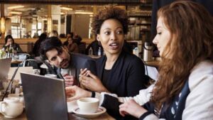 Young people in a café with a laptop and coffee.