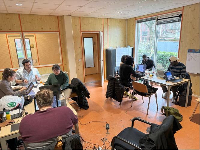 students seated at desks working on laptops