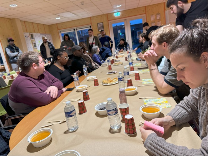 students gathered around a table preparing to eat