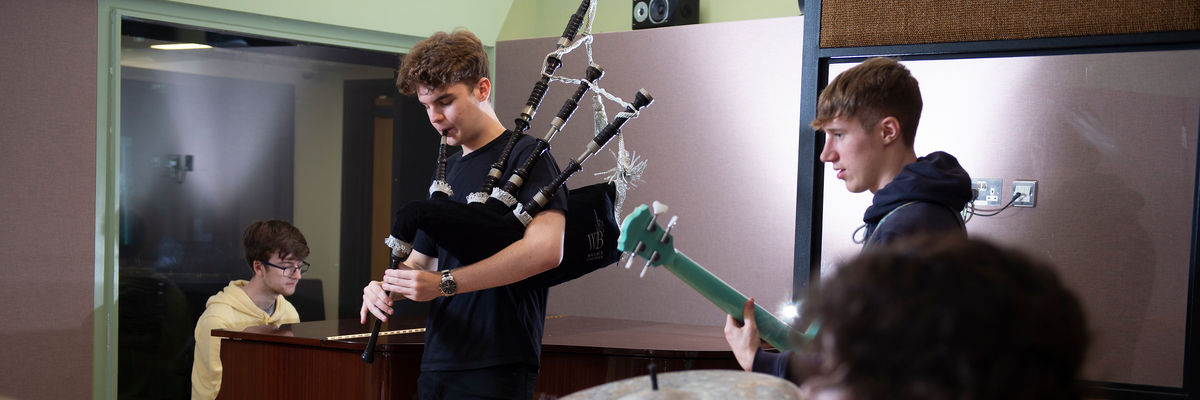 boy playing bagpipes band v1