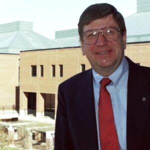 Robert “Bob” Barnhardt, former dean of Wilson College of Textiles, stands in front of the college.