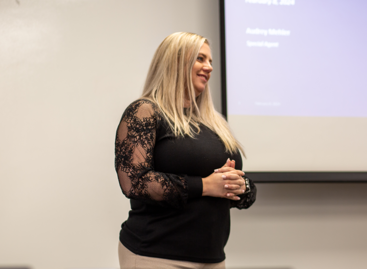 NICB Agent in a black top speaking in front of a room