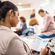 Young adult reading brochure in clinic waiting room