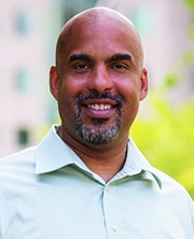 A portrait headshot of Damien Fair PA-C, Ph.D.