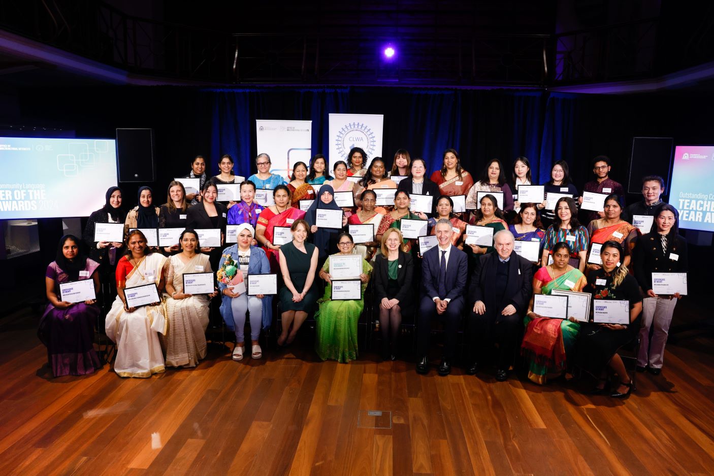 Group photo of all award winners and nominees on stage.