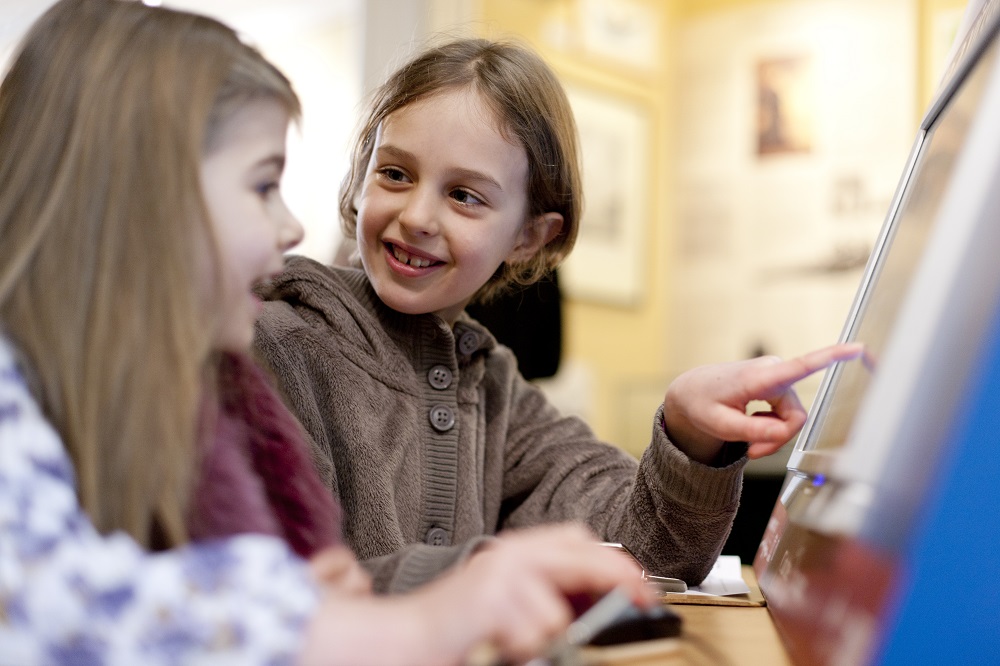 two girls playing with touch screen