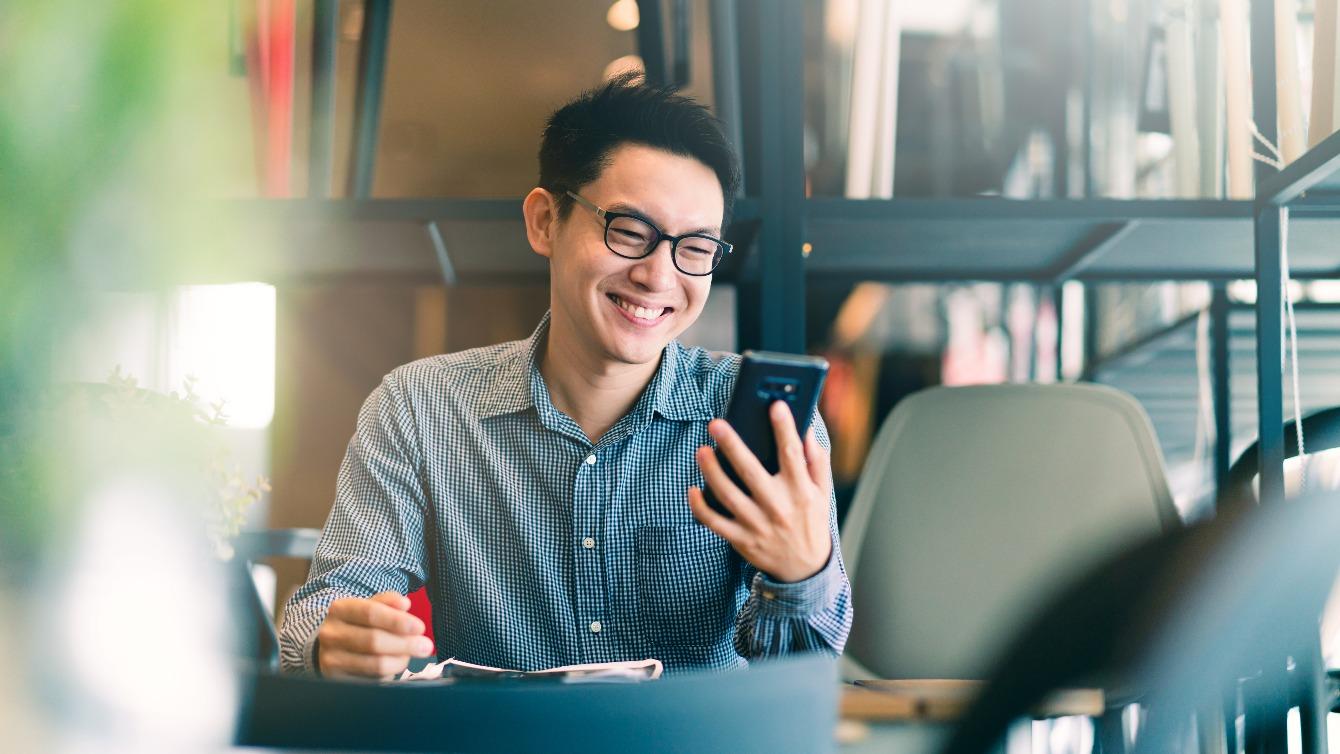 man smiling at phone