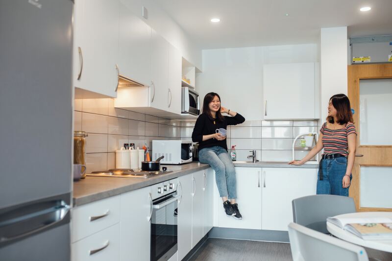 Students talking in kitchen