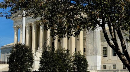 The Supreme Court building behind fall leaves