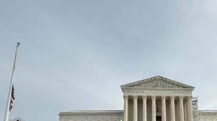 The Supreme Court building and American flag