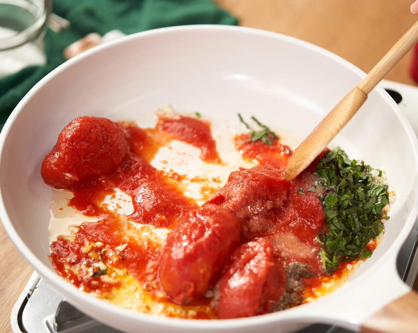 step 3 Once tomatoes become soft, use a wooden spoon to crush and break them down into small pieces. Let the sauce simmer over low heat for 10 more minutes until the sauce is ready.