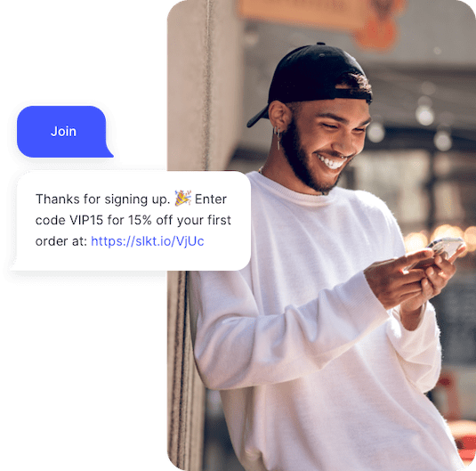 Happy young man receives an automated SMS campaign with 15% off his first order.