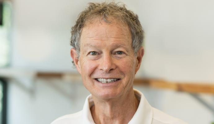 John Mackey, smiling, in a sunny room