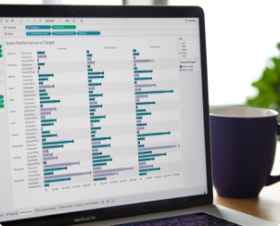 Photograph of Tableau on a laptop with a coffee mug in the background