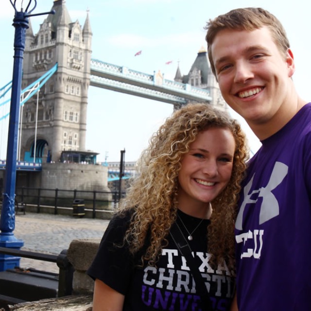 A female and male student standing in front of Tower Bridge in London