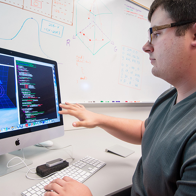 Student works on a 3D simulation of a hand