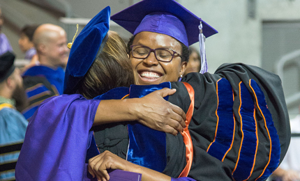 Professor hugging a graduate