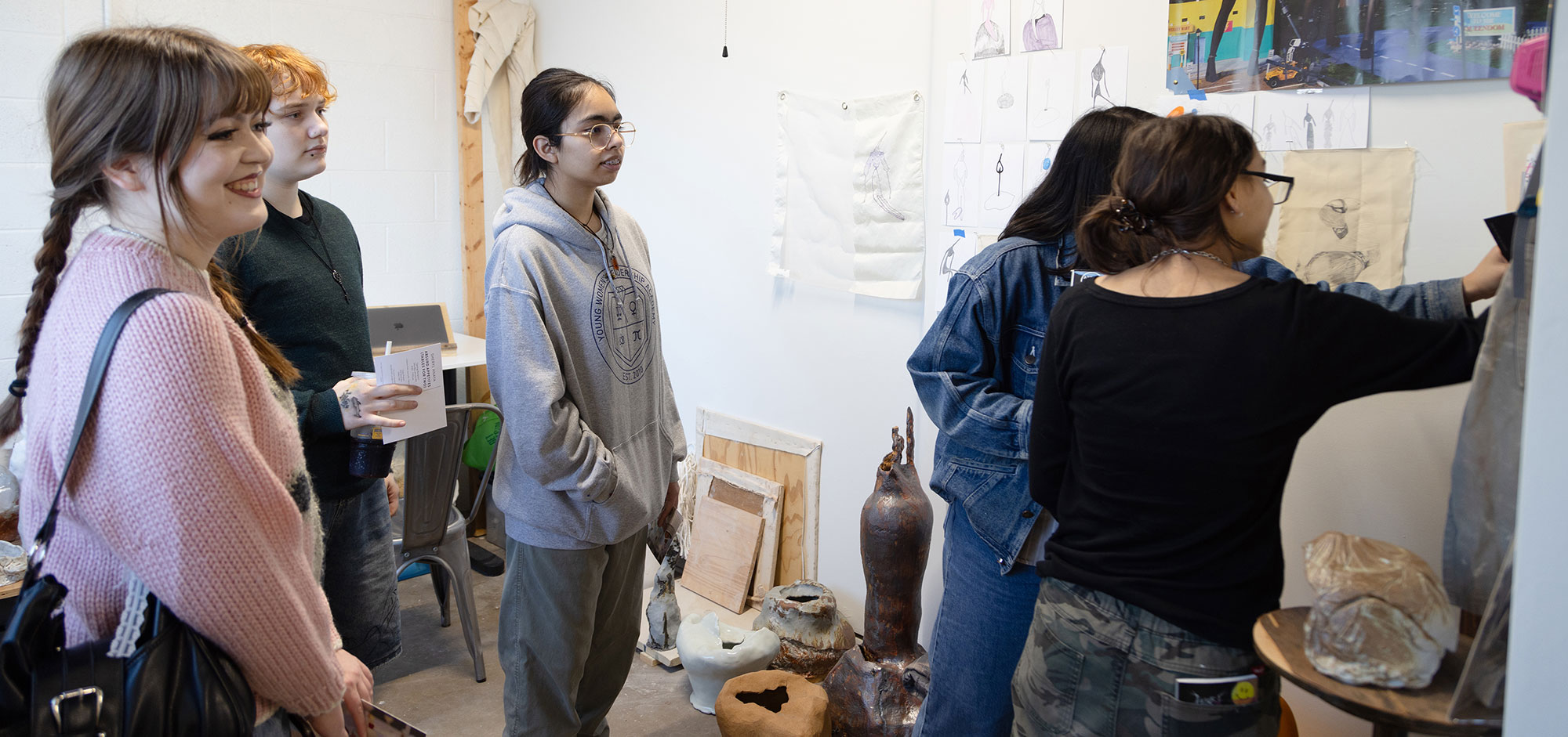 Teens looking at art in the studio