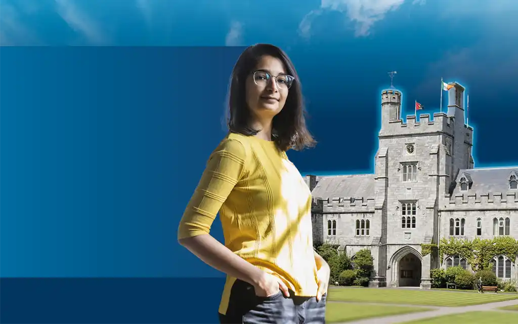 a female student standing in front of the clock tower