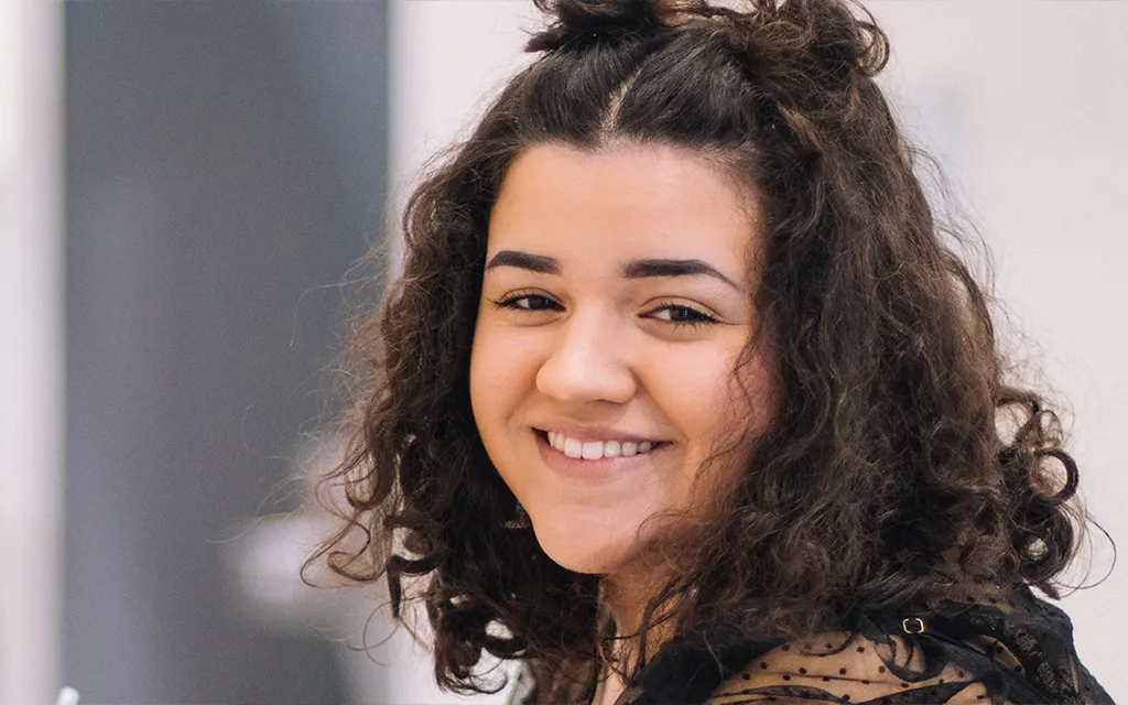 A student smiling at the camera