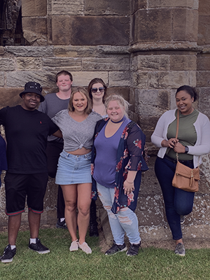 group shot of students outside a castle