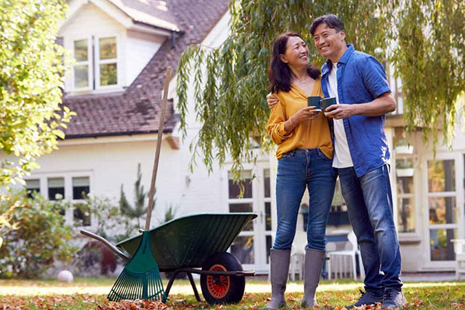 Couple standing outside of home