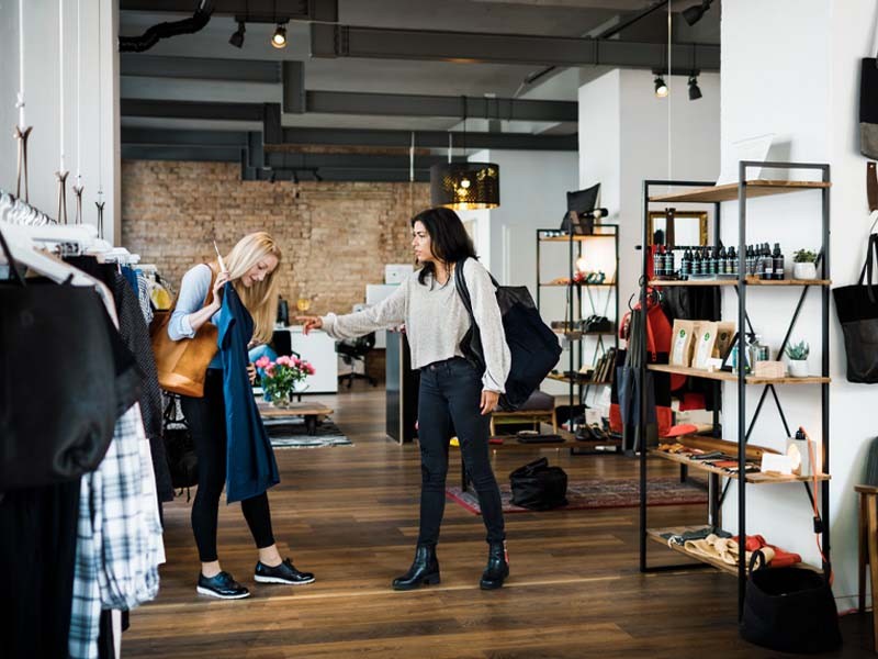 Two women choosing the clothes to pick