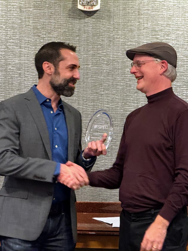 Alex Carlton accepting award from David Reiner